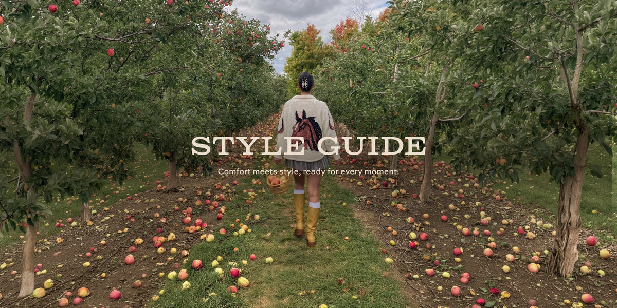 A person viewed from behind walking through an apple orchard path, wearing a light beige jacket, dark pants, and yellow rain boots. Large overlaid text reads 'STYLE GUIDE' with smaller text below.